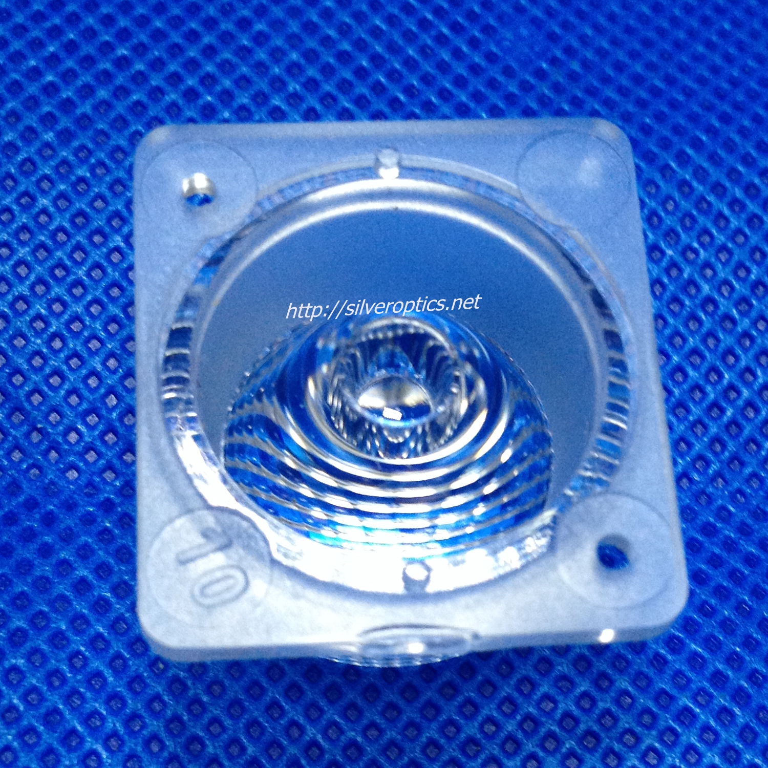 Circular optical component with concentric surface features and a mounting flange