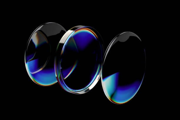 Three circular optical elements with colored reflected light against a dark background